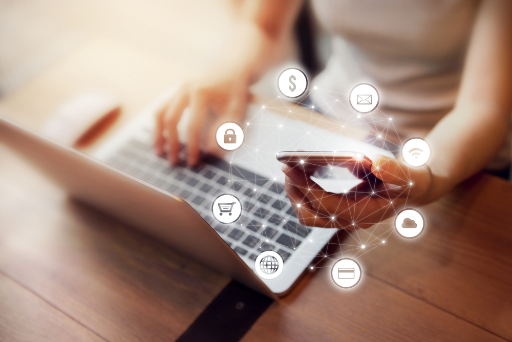 a woman holding her phone showing with you the graphic icon multichannel online.