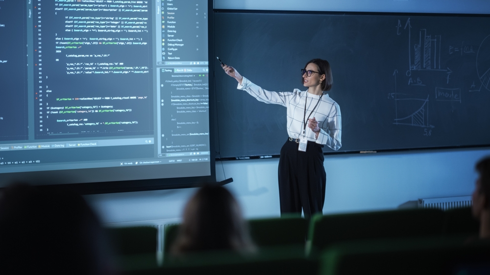 a young university professor prominently explaining the coding strategy and techniques.